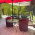 Nubes Hotel in Viña del Mar patio with outdoor seating, red umbrellas, and potted plants
