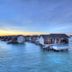 The Residence Maldives in Falhumaafushi with overwater villas and a private ocean pool at sunset