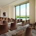 Minsk Marriott Hotel meeting room with rows of chairs and floor-to-ceiling windows overlooking greenery