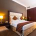 Flora Park Deluxe Hotel Apartments in Dubai guest room with king bed and large wardrobe