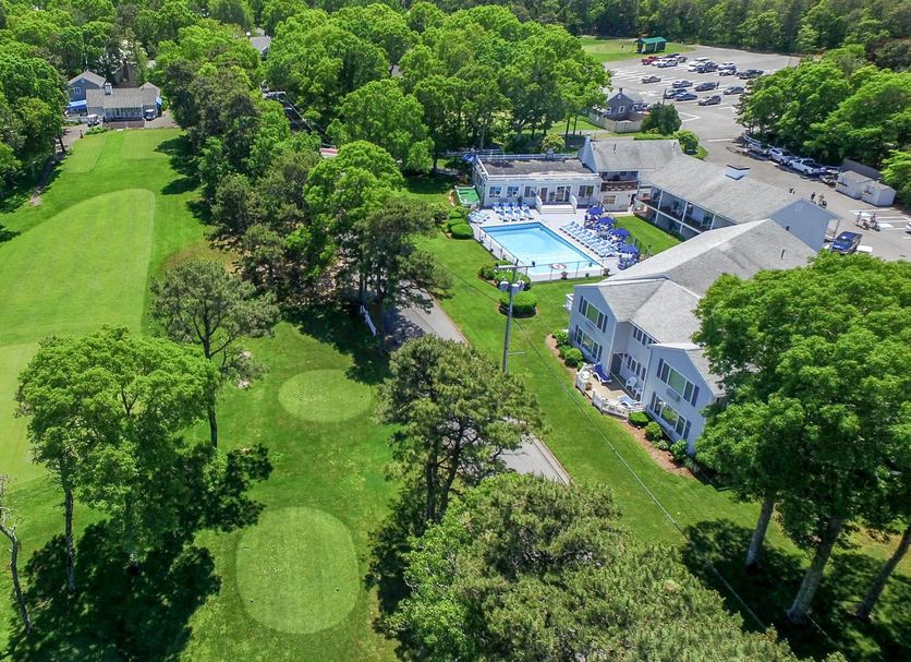Blue Rock Resort in South Yarmouth with golf course, outdoor pool, and tree-lined grounds