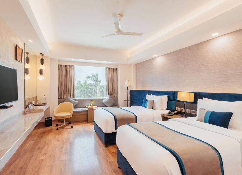 The Piccadily Lucknow guest room with two beds and a window view in Lucknow