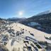 Snowy mountain valley view from Madrisa Lodge in Klosters-Serneus with sunlit peaks and slopes