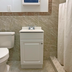 Red Carpet Inn & Suites Morgantown bathroom with toilet, vanity sink, and shower curtain
