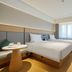Ji Hotel Urumqi Hongshan guest room in Ürümqi with twin beds and large window