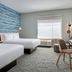 TownePlace Suites by Marriott Brunswick guest room with two beds, desk, chair and window