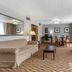 Comfort Inn & Suites Glen Mills - West Chester suite with sofa, dining table, TV and large window