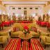 Hotel Ghanerao Castle Ranakpur lounge in Ghanerao with sofas, chairs, and striped rug