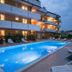 Ferretti Residence Garda Palace in Peschiera del Garda, outdoor pool and sun loungers at dusk
