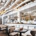 Minsk Marriott Hotel, Minsk: spacious hotel restaurant with chefs at an open kitchen and dining tables