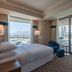 Four Points by Sheraton Izmir room with balcony, city and mountain views, and a sofa seating area