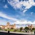 Alo Inka Hotel in Cusco with a plaza view of historic buildings and a dramatic cloudy sky