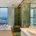 The Clouds Apartment in Shenzhen bathroom with soaking tub, mosaic shower and city skyline view