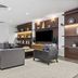 DoubleTree by Hilton New York JFK Airport in Queens: modern lounge with sofa seating, TV, and built-in shelves