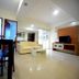 High Point Surabaya living room with sofa, TV, and sliding glass door
