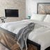 Pikes Peak Paradise Bed and Breakfast bedroom in Woodland Park with king bed and wood headboard