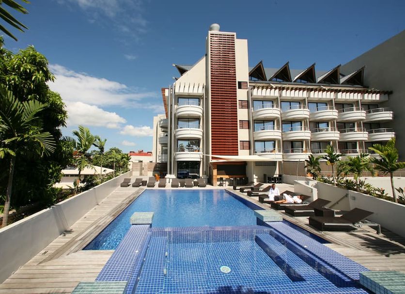 Hotel Tahiti Nui in Papeete with a rooftop pool, lounge chairs, and a modern hotel exterior