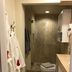 Studio Suite at Marina Cabo Plaza in Cabo San Lucas bathroom with glass shower, toilet, and robes