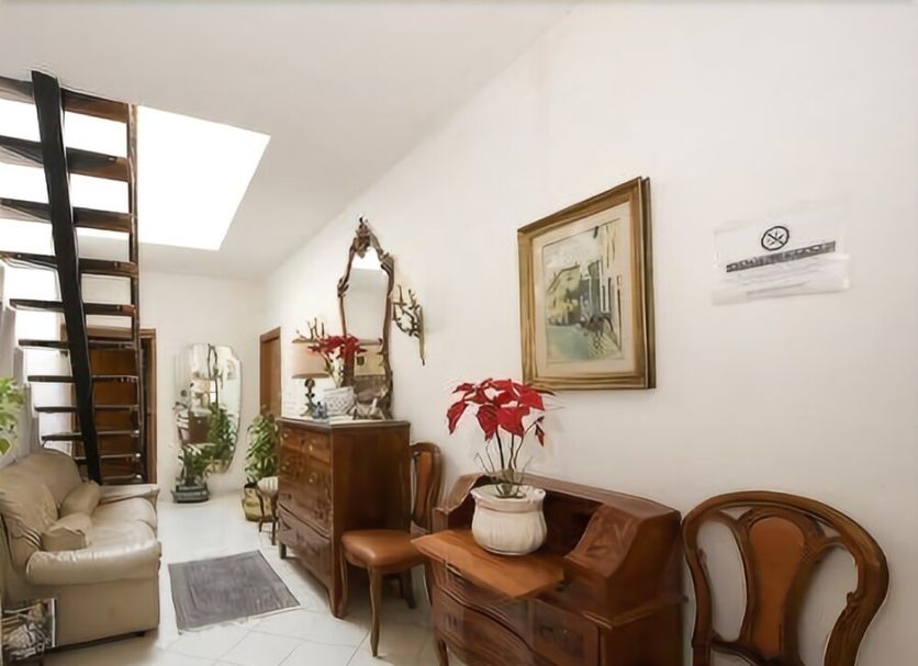 Soggiorno Burchi in Florence hallway with staircase, skylight, vintage chairs and wooden desk
