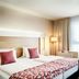 Best Western Plus Welcome Hotel Frankfurt guest room with twin beds, seating area and large window in Frankfurt am Main