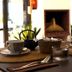 Hotel Es Blau Des Nord in Artà: tea set and glassware on a dining table beside a fireplace