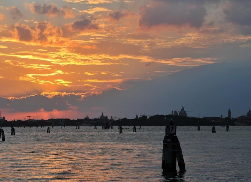 Hotel Cristallo Venice with sunset over Venetian lagoon and silhouetted skyline
