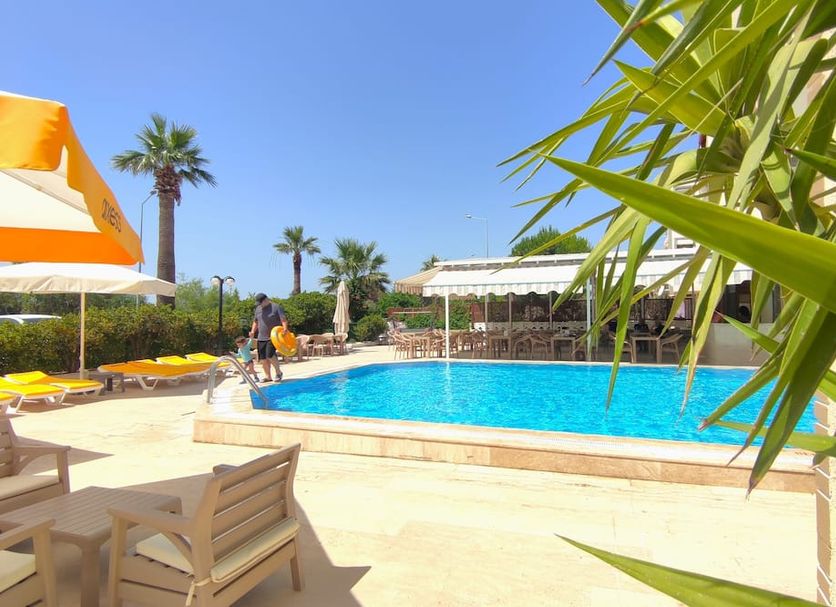 Mulka Hotel in Ayvalik with outdoor pool, sun loungers and palm trees