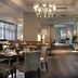 Dining area at AC Hotels by Marriott Ambassadeur Antibes- Juan les Pins in Antibes with set tables and chandeliers