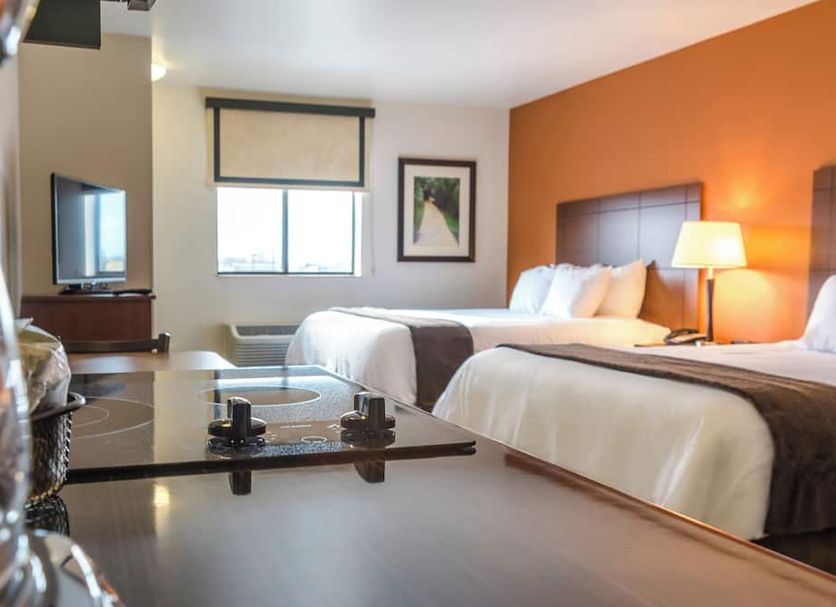 My Place Hotel-Council Bluffs/Omaha East, Ia guest room with two beds, TV, and window