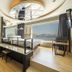 JK Hotel Busan room with circular skylight, loft bed, and ocean view