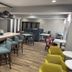 Hampton Inn Corpus Christi-Northwest I-37 lounge with tables, chairs, and colorful seating