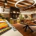 Hotel Cala del Pi - Adults Only buffet dining area in Platja d'Aro with fruit, pastries and open kitchen