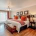 Sunward Park Guest House & Conference Centre in Boksburg: guest room with king bed, TV, desk and balcony doors