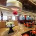 Beijing Marriott Hotel Northeast restaurant with red chairs, buffet counter, and large dining room in Beijing