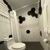 Hotel Nest, San Juan bathroom with hexagon tile shower, toilet, and black accent wall tiles