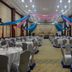 Mawlamyine Strand Hotel in Mawlamyine banquet hall with round tables and blue-pink draped ceiling