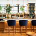 Arrive Memphis bar with velvet stools, shelves of bottles, and hanging plants in Memphis