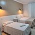 Faixa Hotel in Vitória da Conquista, twin guest room with two beds, wall lights, TV and air conditioner