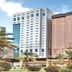 Barakat Burhan Hotel in Mecca with tall modern towers and palm trees in front