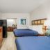 Extended Stay Suites Cookeville - Tennessee Tech guest room with two beds, TV, and kitchenette