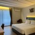 Wyndham Garden Shahzan Fraser's Hill guest room with king bed, wall art, and balcony curtains