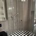 Schloss Hotel Dresden Pillnitz bathroom with glass shower, checkered floor, and wall-mounted towel warmer in Dresden