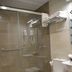 Hotel Doña Lina Seville bathroom with glass shower, toilet, sink and towel rack