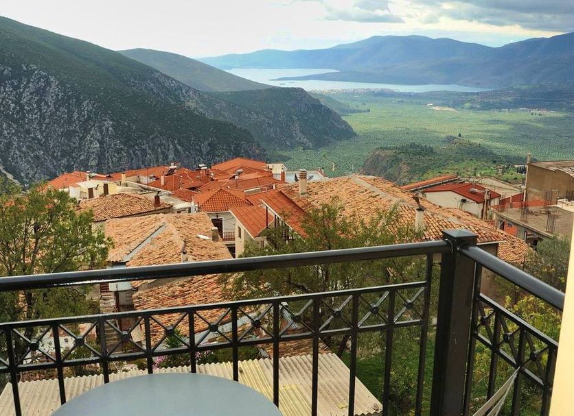 Castri Hotel in Delphi with balcony view over terracotta rooftops and mountain valley