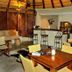 La Lechere Guest House in Phalaborwa lounge with bar stools, seating area, and wooden dining table