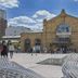 Hotel Les Portes D'Or in Nancy with a historic stone facade and people gathered in the plaza