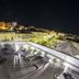 Relais La Pretura in Vieste: rooftop terrace with lounge chairs and night view over the town