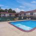 Motel 6 Meridian Ms outdoor pool with motel rooms surrounding the courtyard in Meridian