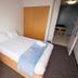 Humber College Lakeshore Residence Toronto room with double bed, desk, and open doorway to sitting area