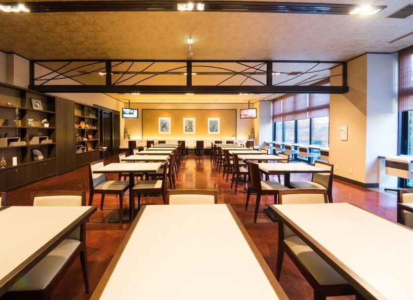 Dormy Inn Premium Kyoto Ekimae Natural Hot Spring dining room with rows of tables and chairs in Kyoto